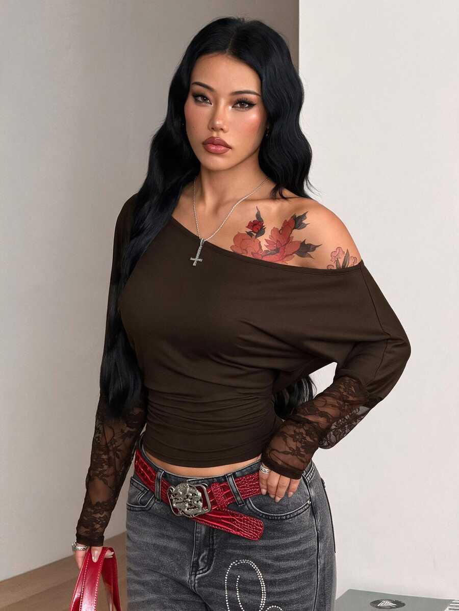 Women's black long sleeve t-shirt featuring delicate contrast lace details and a boat neckline in a knitted stretch fabric.