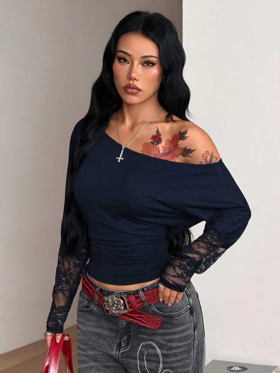Women's black long sleeve t-shirt featuring delicate contrast lace details and a boat neckline in a knitted stretch fabric.