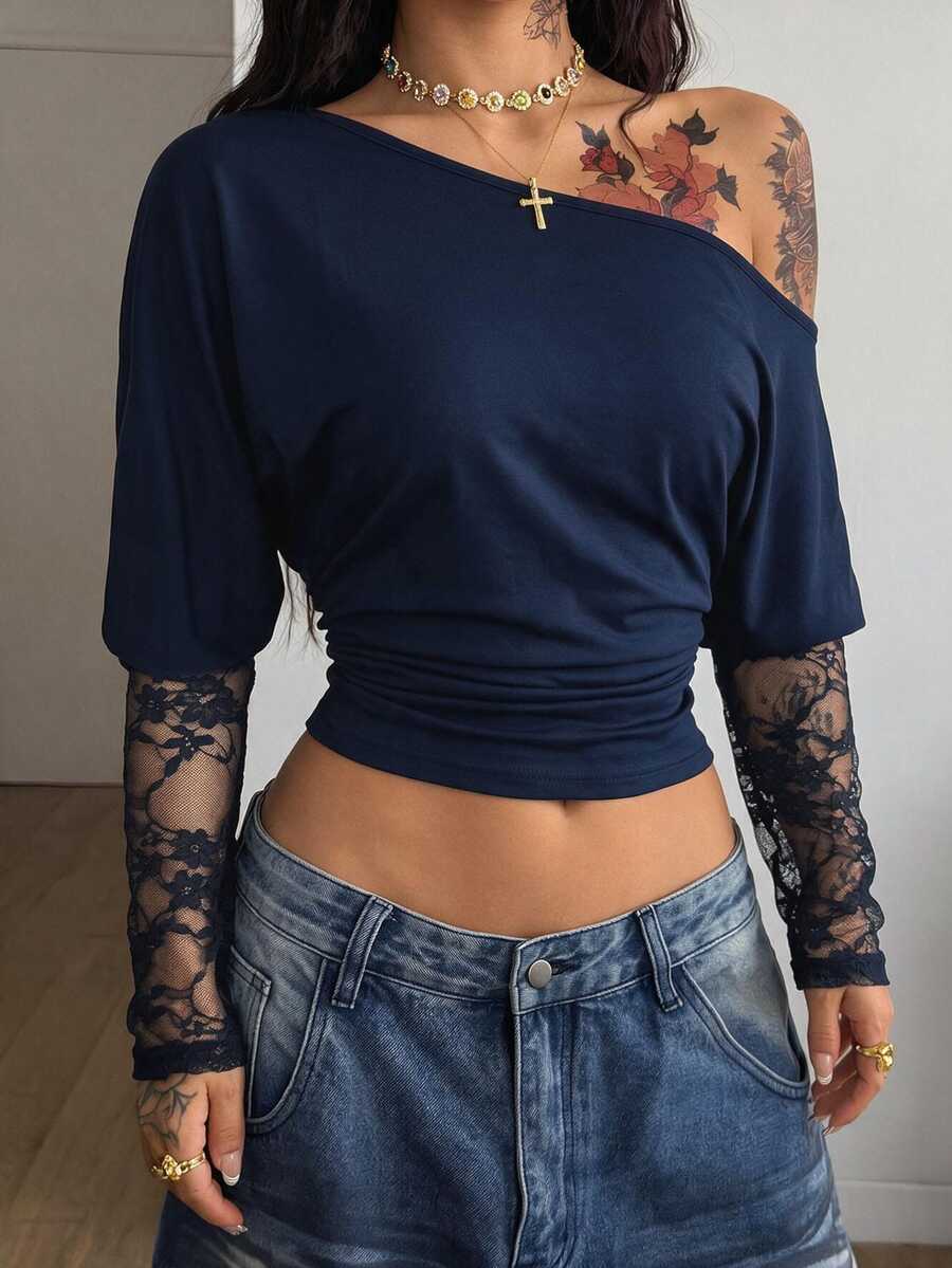 Women's black long sleeve t-shirt featuring delicate contrast lace details and a boat neckline in a knitted stretch fabric.