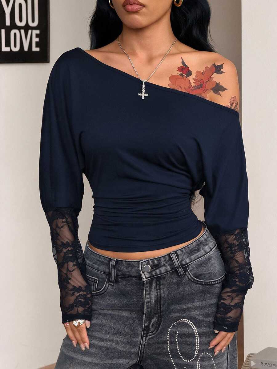 Women's black long sleeve t-shirt featuring delicate contrast lace details and a boat neckline in a knitted stretch fabric.