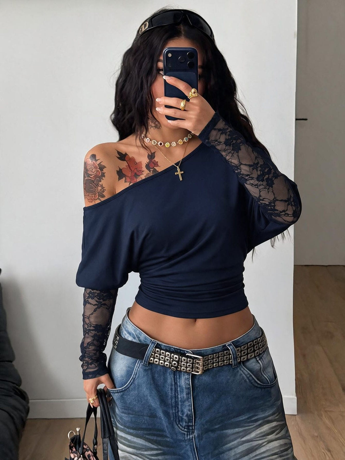 Women's black long sleeve t-shirt featuring delicate contrast lace details and a boat neckline in a knitted stretch fabric.