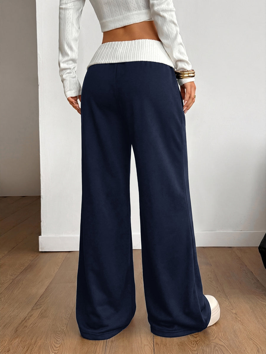 Women's wide leg flare lounge pants made of 95% cotton with a low elastic waistband and extra long hem.