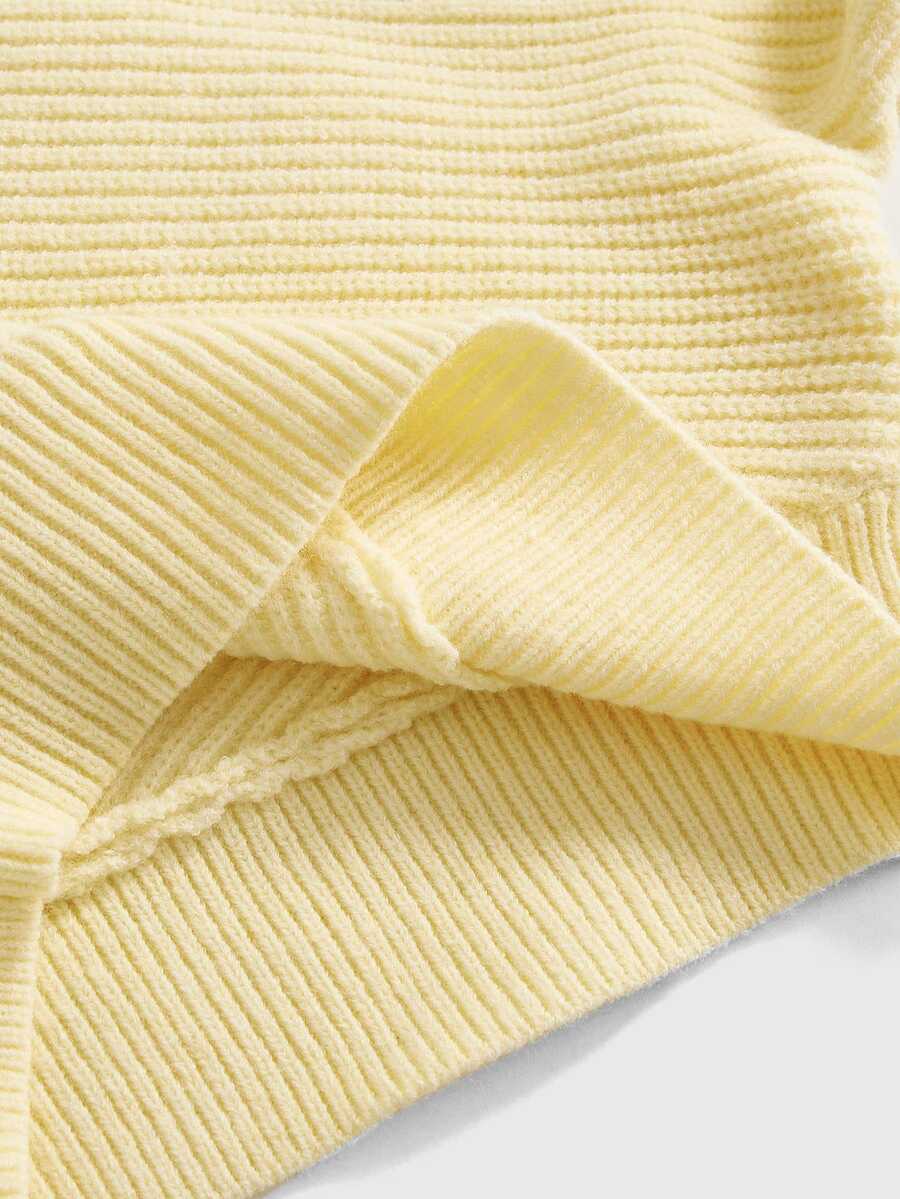 Women's two-piece rib-knit sweater set featuring a long-sleeve cold-shoulder crop top with strap details and matching wide-leg pants.