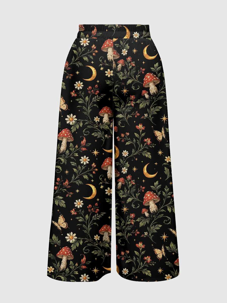 Women's plus size black gothic wide leg pants with split thigh detail and celestial moth, sun, and star pattern.