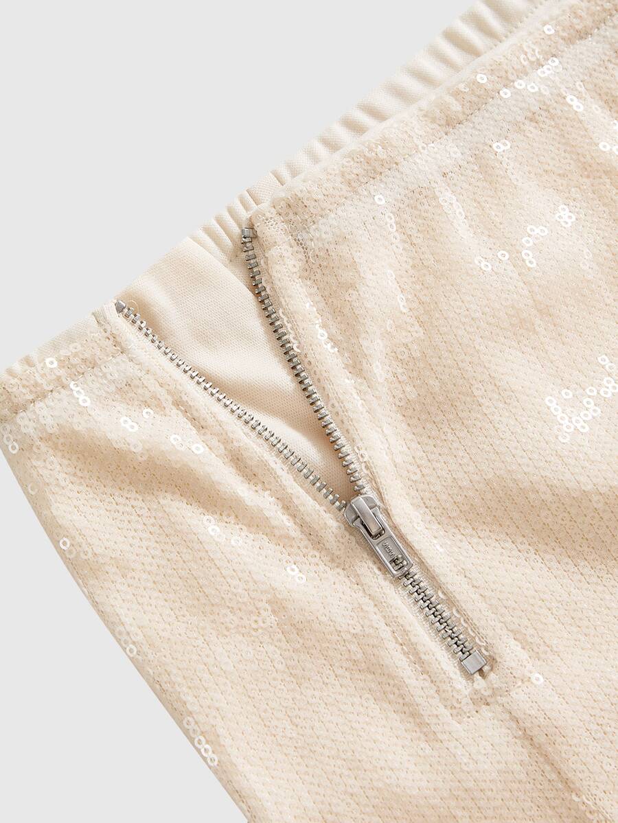 Women's low waist sequin mini shorts featuring shimmering contrast sequins and a zipper fly closure.