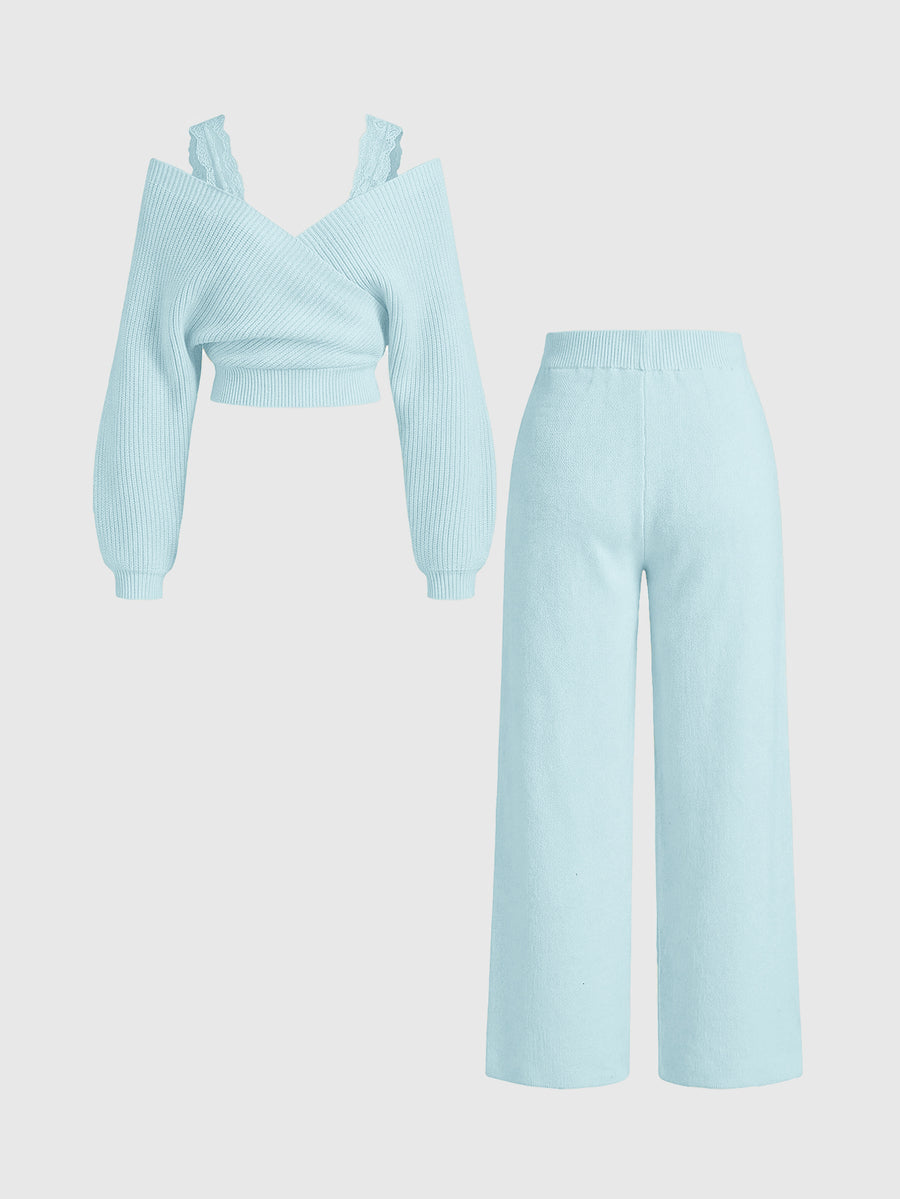 Women's two-piece rib-knit sweater set featuring a long-sleeve cold-shoulder crop top with strap details and matching wide-leg pants.