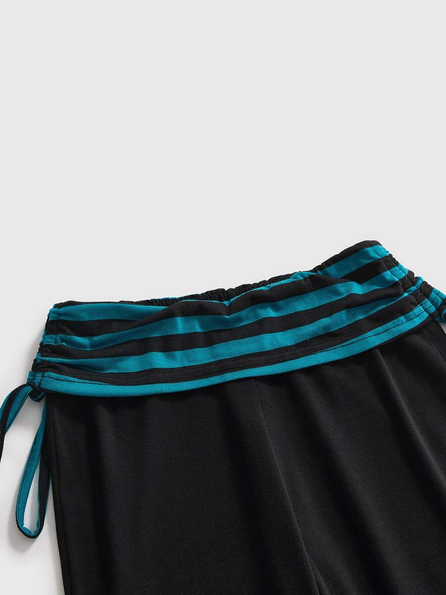 Women's low waist flare leg pants featuring an elastic drawstring waistband and ruched detail in knitted fabric.