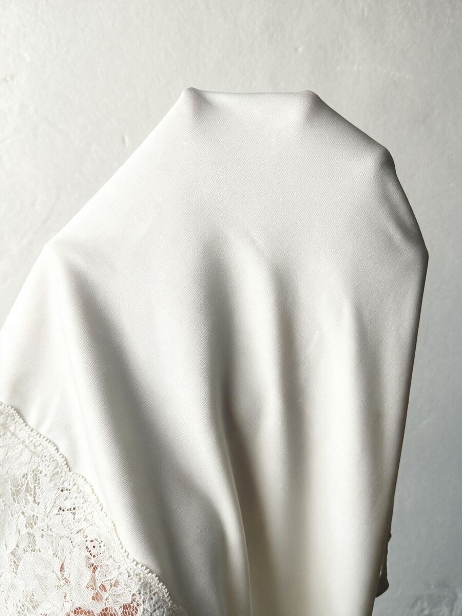 Women's slim fit off the shoulder long sleeve knitted top featuring contrast lace trim and ruched accents.