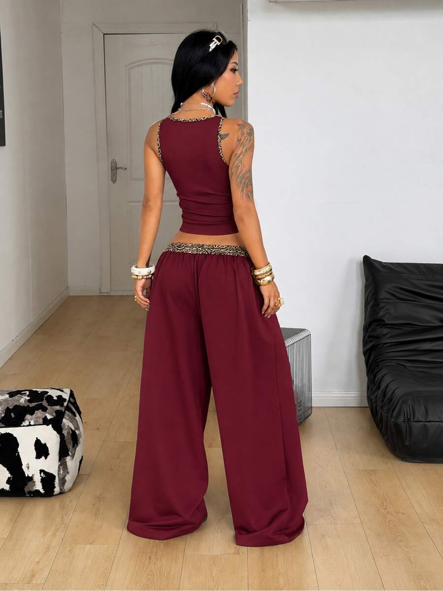 Women's two-piece casual outfit featuring a slim-fit camisole tank top with ruffle trim and button front paired with high-waisted wide leg pants.