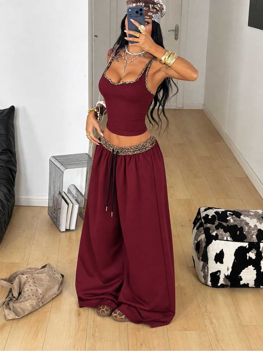 Women's two-piece casual outfit featuring a slim-fit camisole tank top with ruffle trim and button front paired with high-waisted wide leg pants.