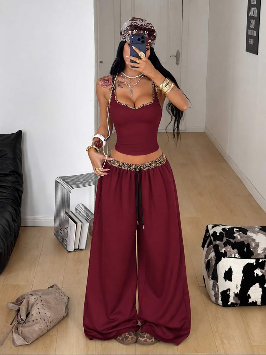 Women's two-piece casual outfit featuring a slim-fit camisole tank top with ruffle trim and button front paired with high-waisted wide leg pants.