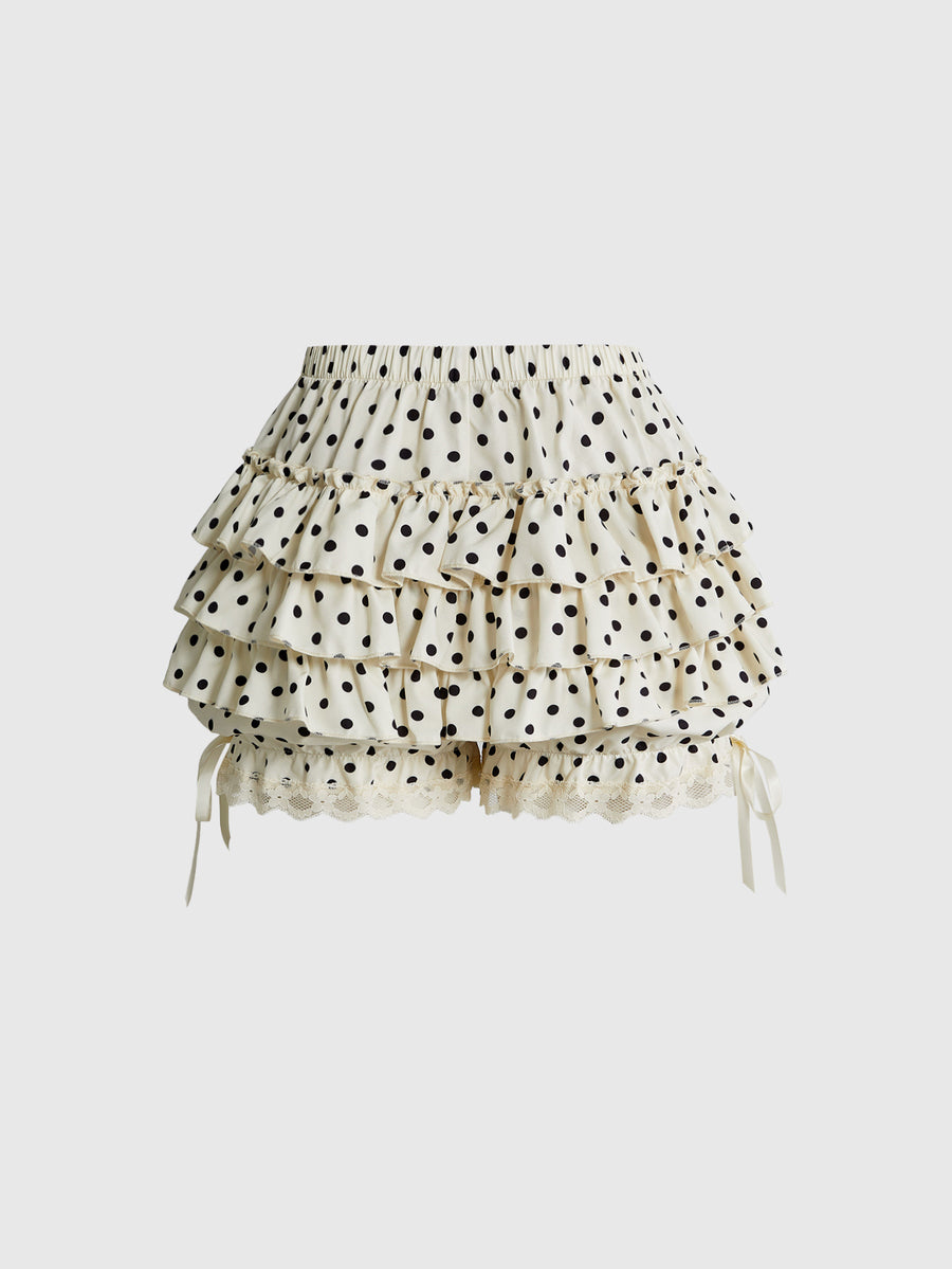 Women's tiered ruffle skort shorts featuring an elastic mid waist with front tie knot detail in woven fabric.