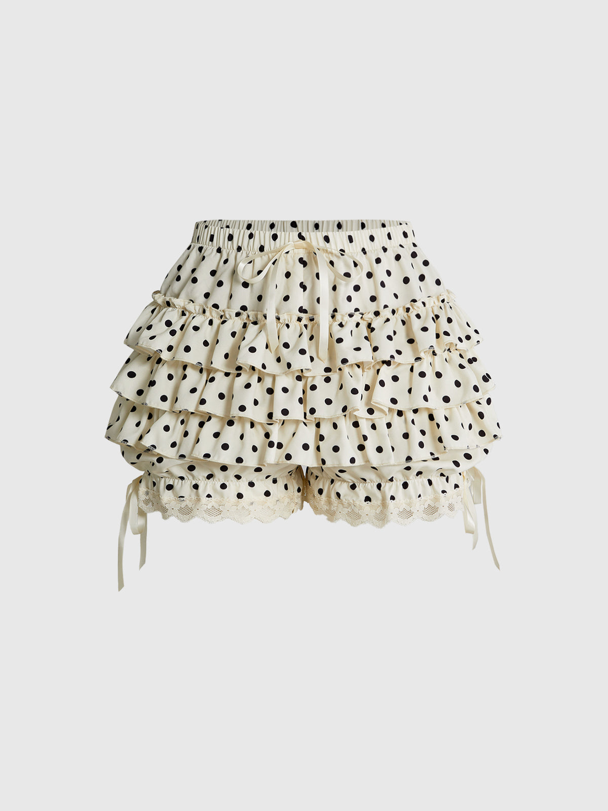 Women's tiered ruffle skort shorts featuring an elastic mid waist with front tie knot detail in woven fabric.