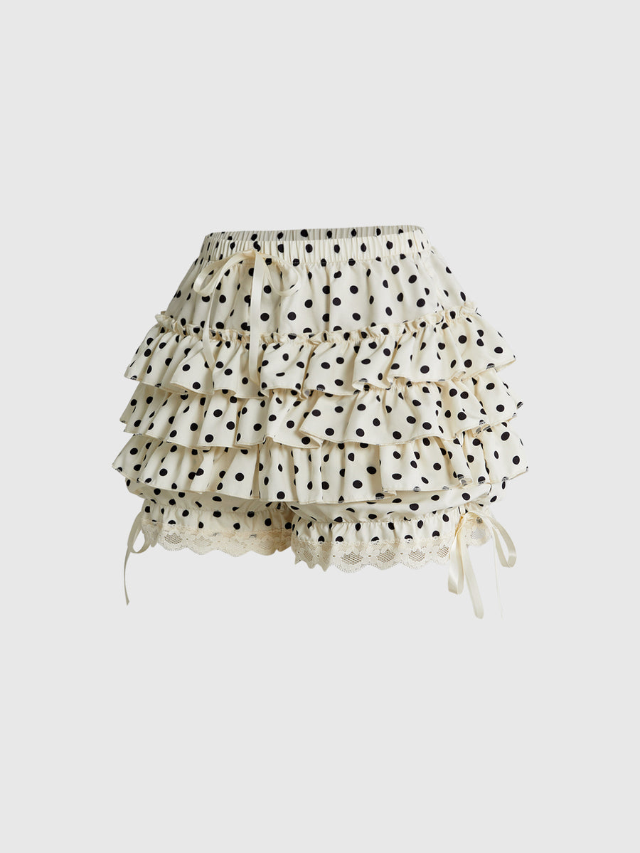 Women's tiered ruffle skort shorts featuring an elastic mid waist with front tie knot detail in woven fabric.
