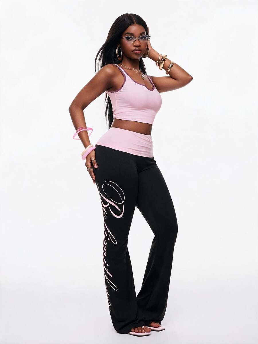 Women's black and white polka dot flare leg pants with side drawstring and ruched details