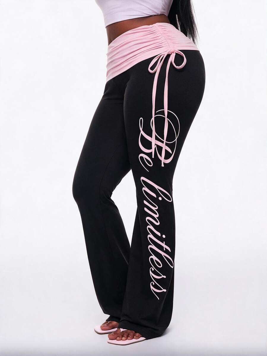 Women's black and white polka dot flare leg pants with side drawstring and ruched details