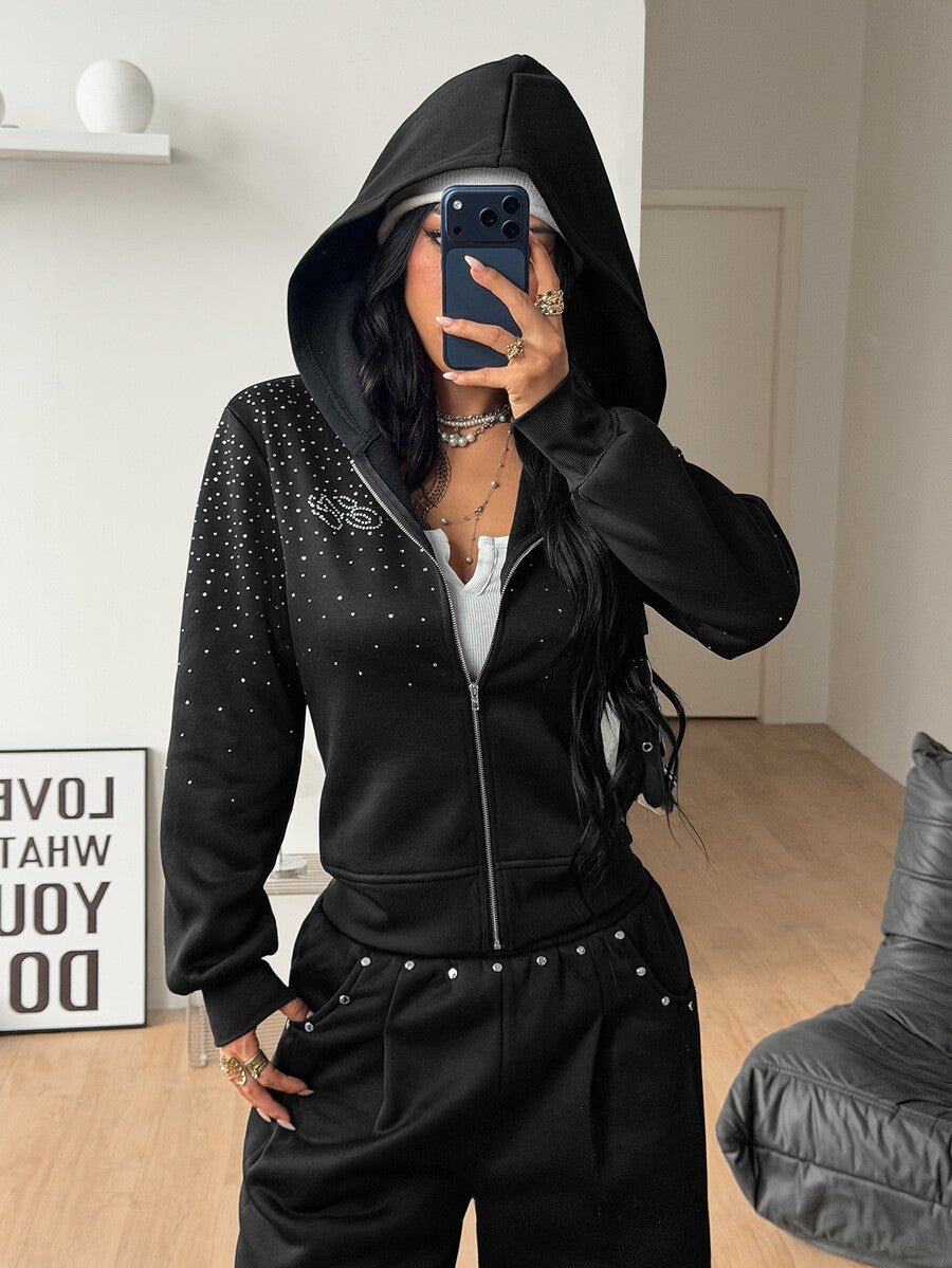 Women's black zip up hoodie featuring long flounce sleeves, a drawstring hood, and front zip closure in a knitted fabric.