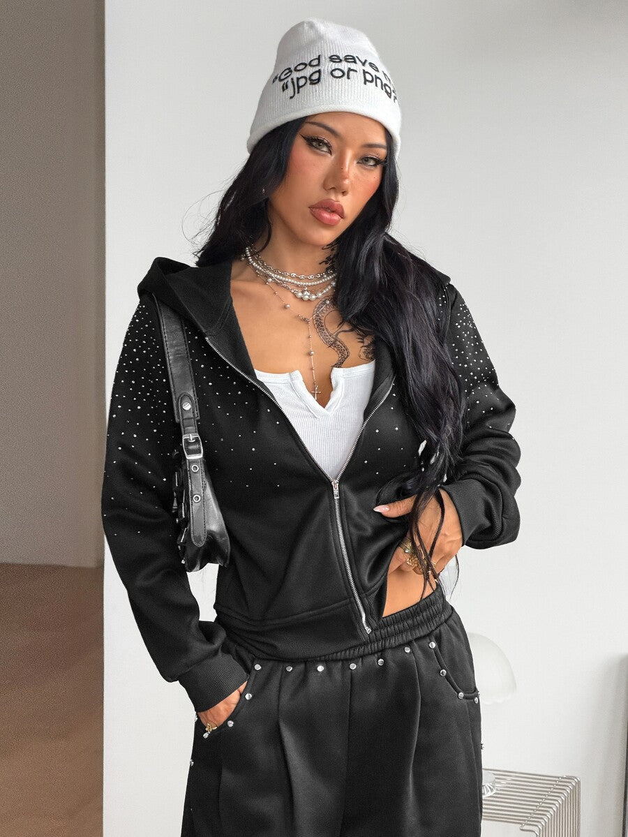 Women's black zip up hoodie featuring long flounce sleeves, a drawstring hood, and front zip closure in a knitted fabric.