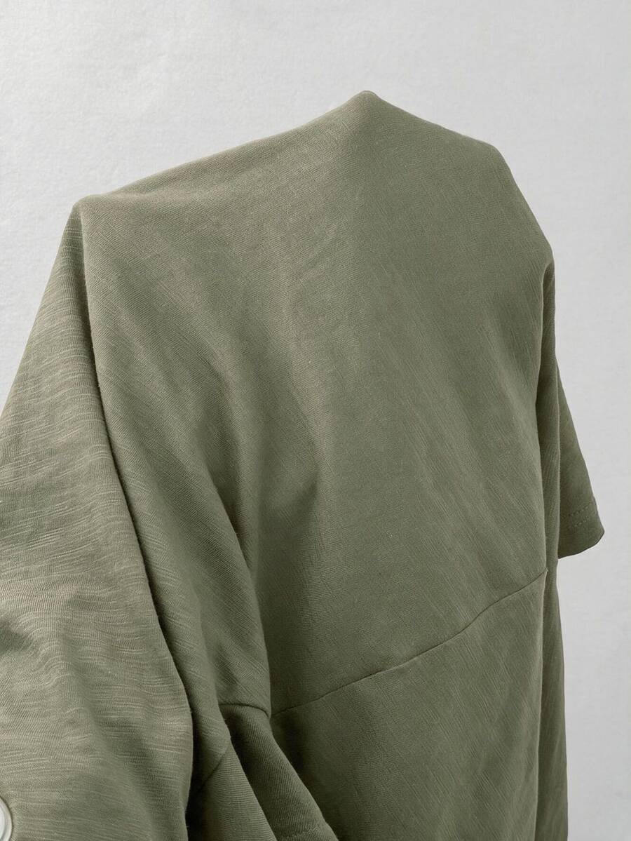 Women's casual loose fit cold shoulder cotton t-shirt with asymmetrical cutout neckline and short sleeves.
