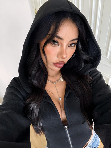 Women's black oversized zip-up hooded sweatshirt with drawstring hood and long sleeves.