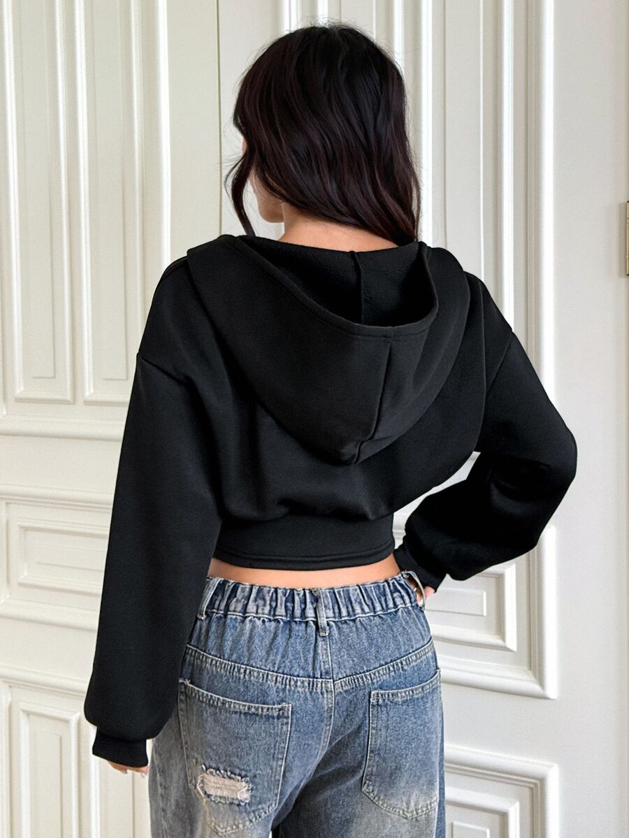 Women's black oversized zip-up hooded sweatshirt with drawstring hood and long sleeves.