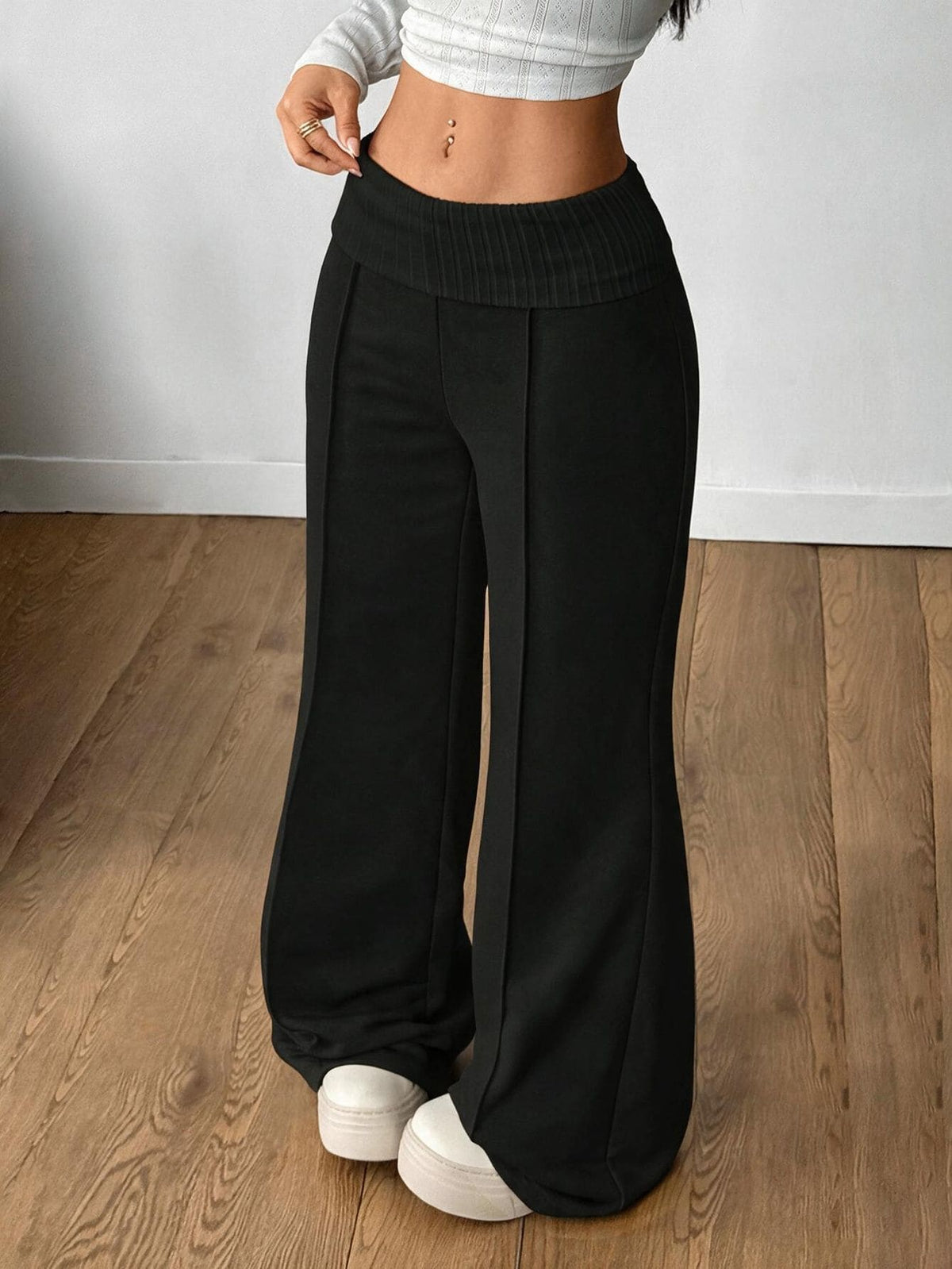 Women's wide leg flare sweatpants featuring a black and white colorblock contrast fold waistband and side stripe details.