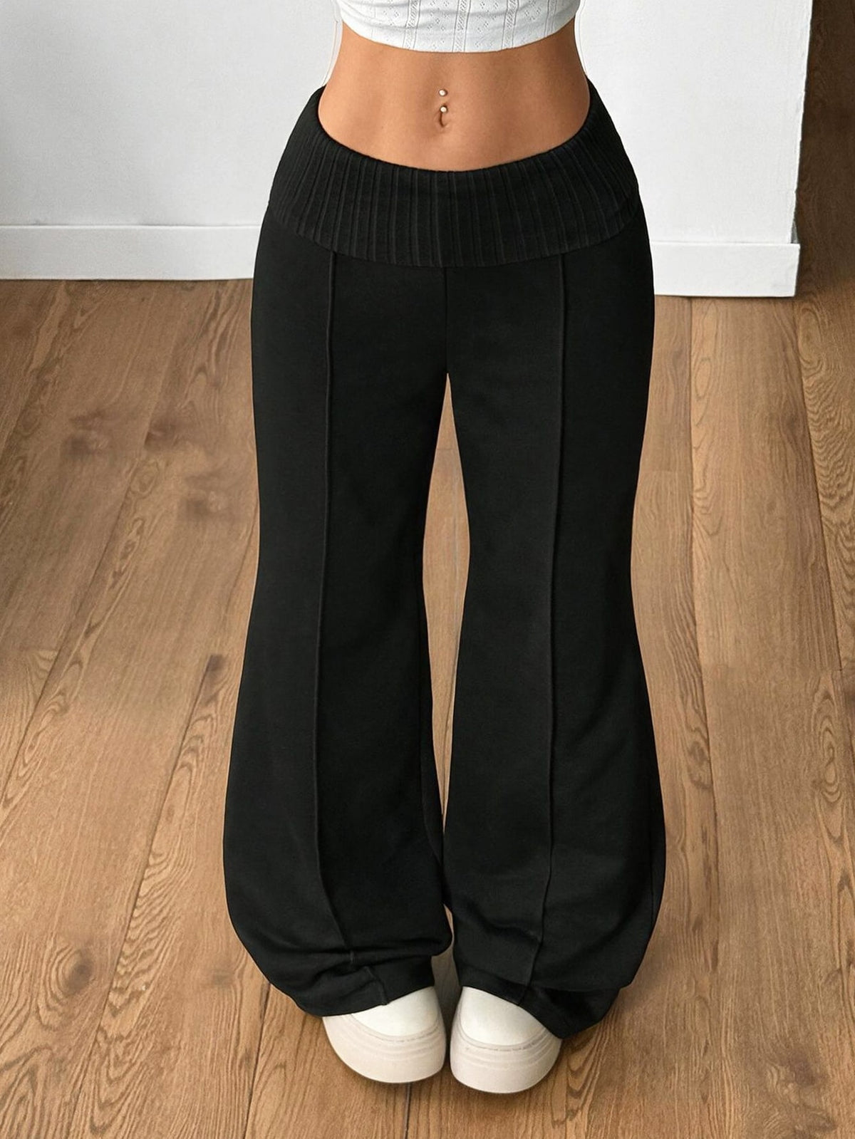 Women's wide leg flare sweatpants featuring a black and white colorblock contrast fold waistband and side stripe details.