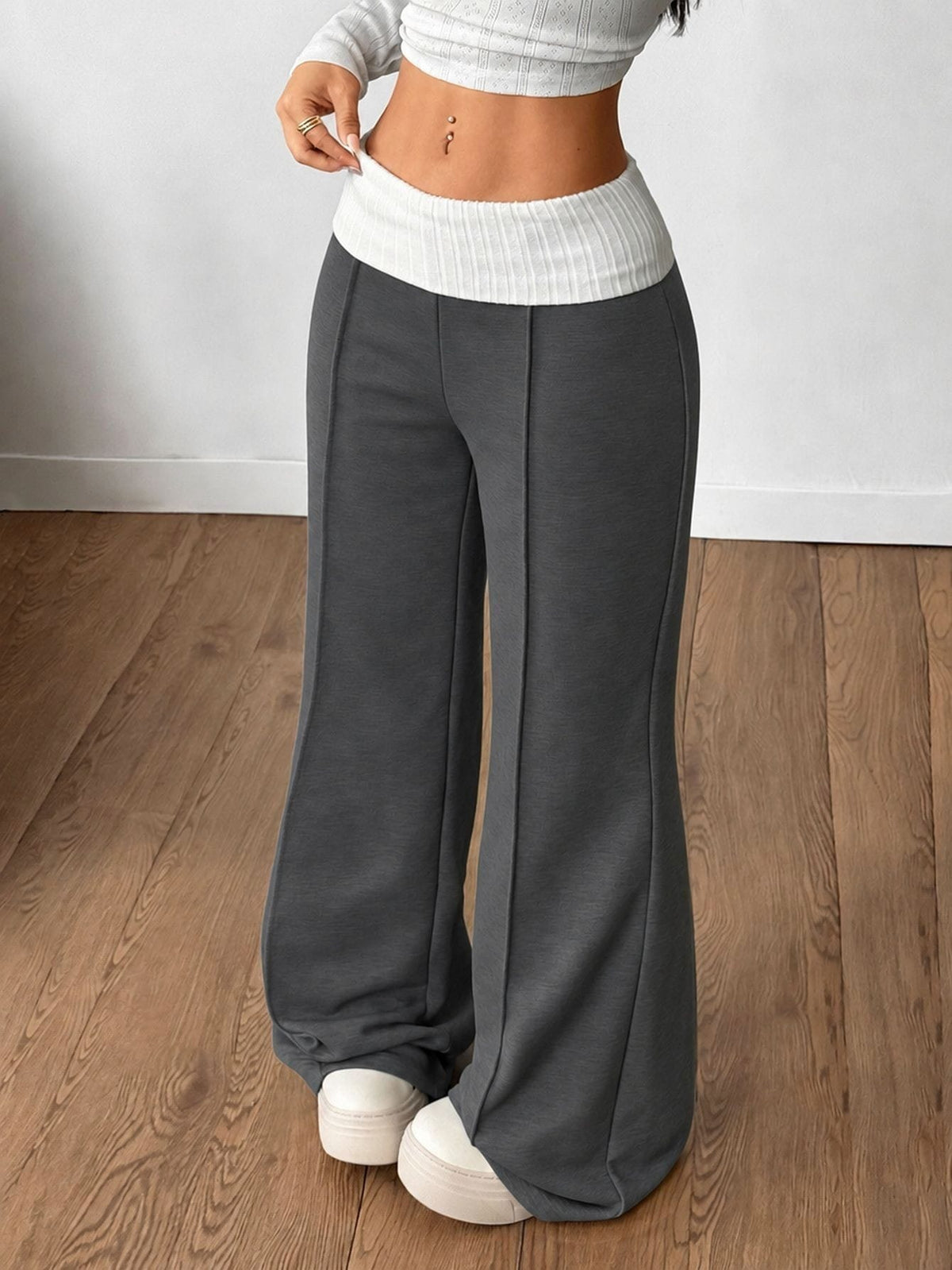 Women's wide leg flare sweatpants featuring a black and white colorblock contrast fold waistband and side stripe details.