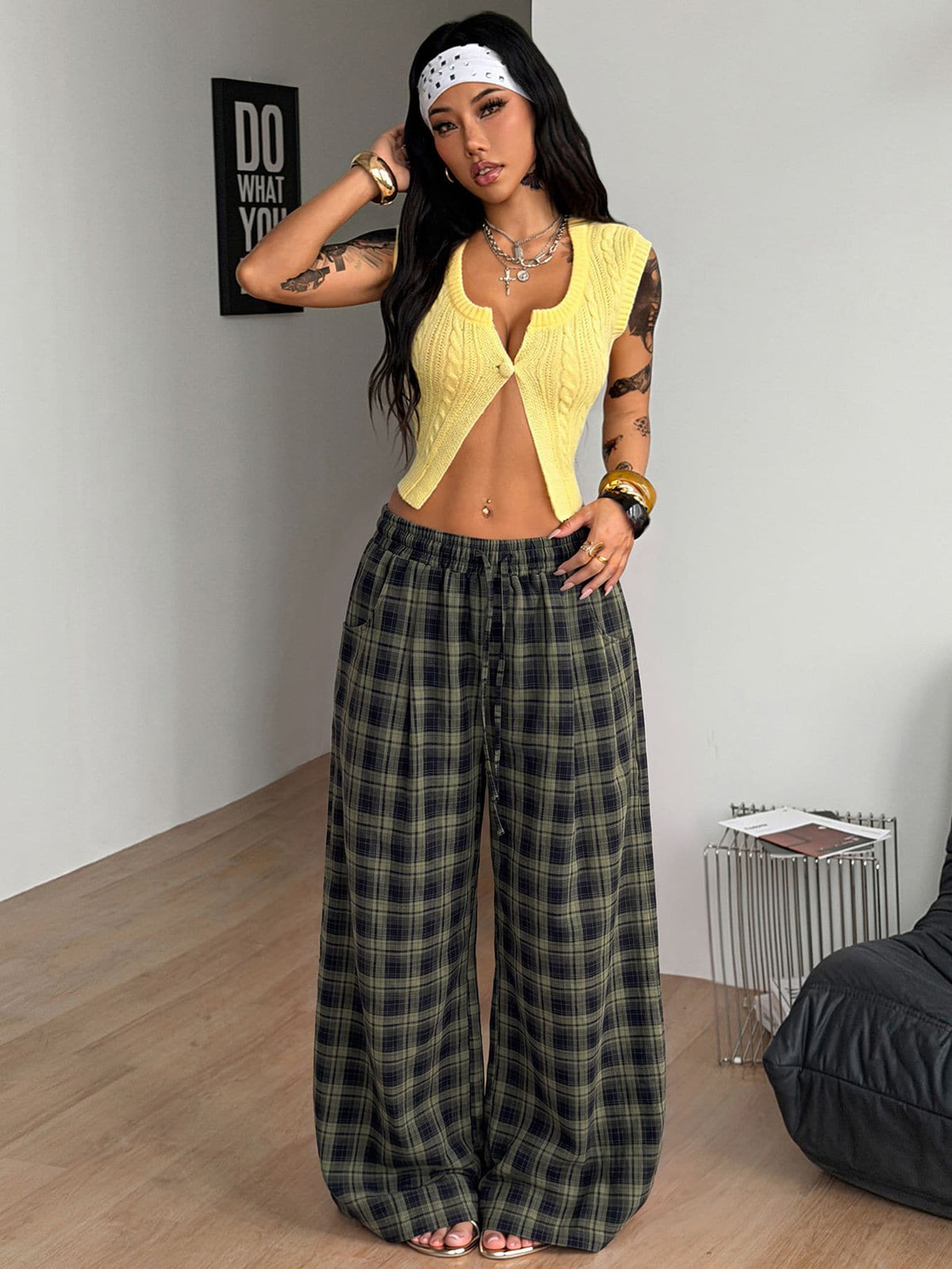 Women's loose fit brown and tan plaid wide leg pants featuring an elastic drawstring waist and side pockets.