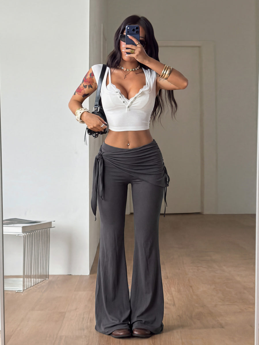 Women's black low rise flare pants with split hem detailing and stretchy knit fabric