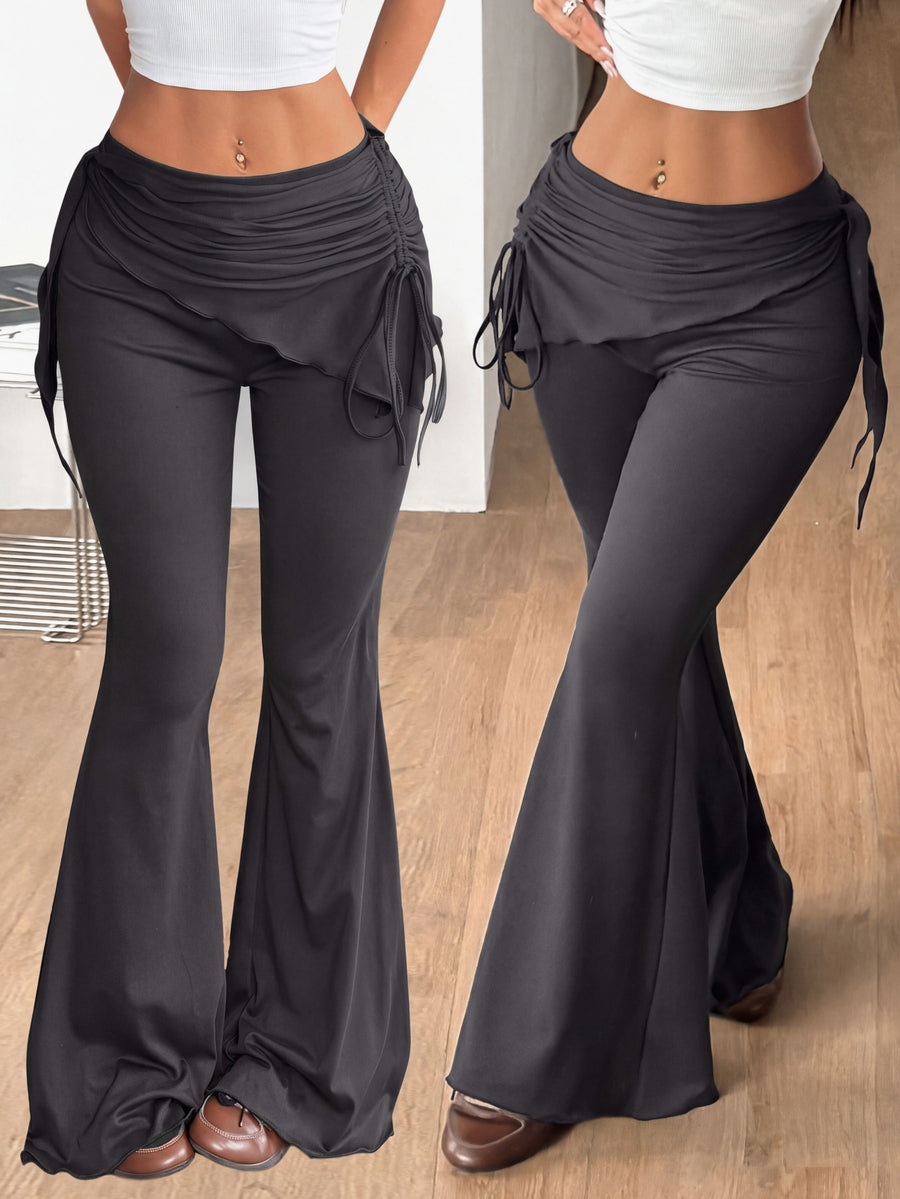 Women's black low rise flare pants with split hem detailing and stretchy knit fabric
