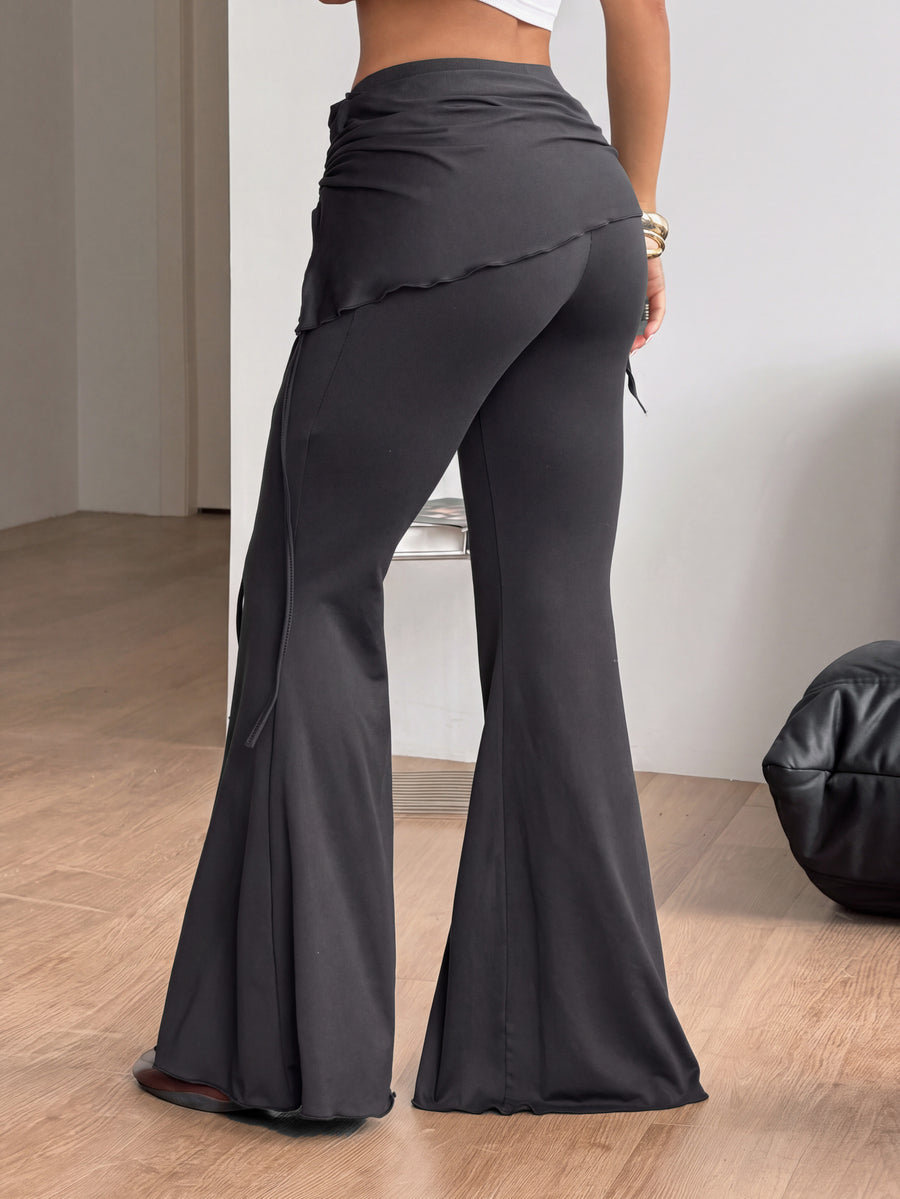 Women's black low rise flare pants with split hem detailing and stretchy knit fabric