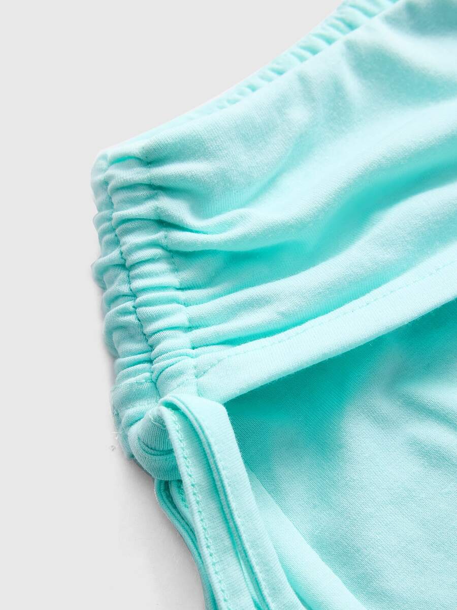 Women's low waist flare leg pants featuring an elastic drawstring waistband and ruched detail in knitted fabric.