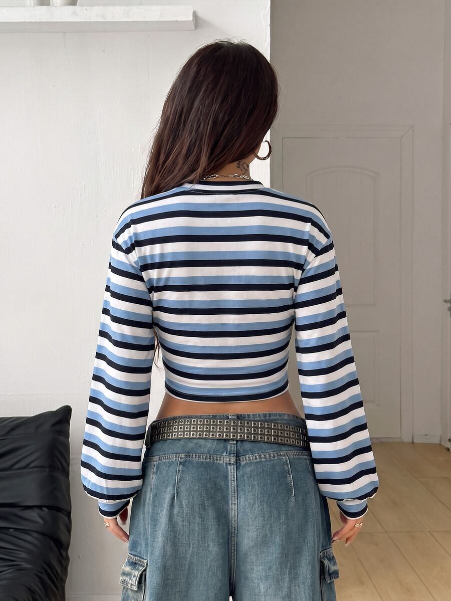 White striped long sleeve pullover sweatshirt for women featuring a round neck and drop shoulders.
