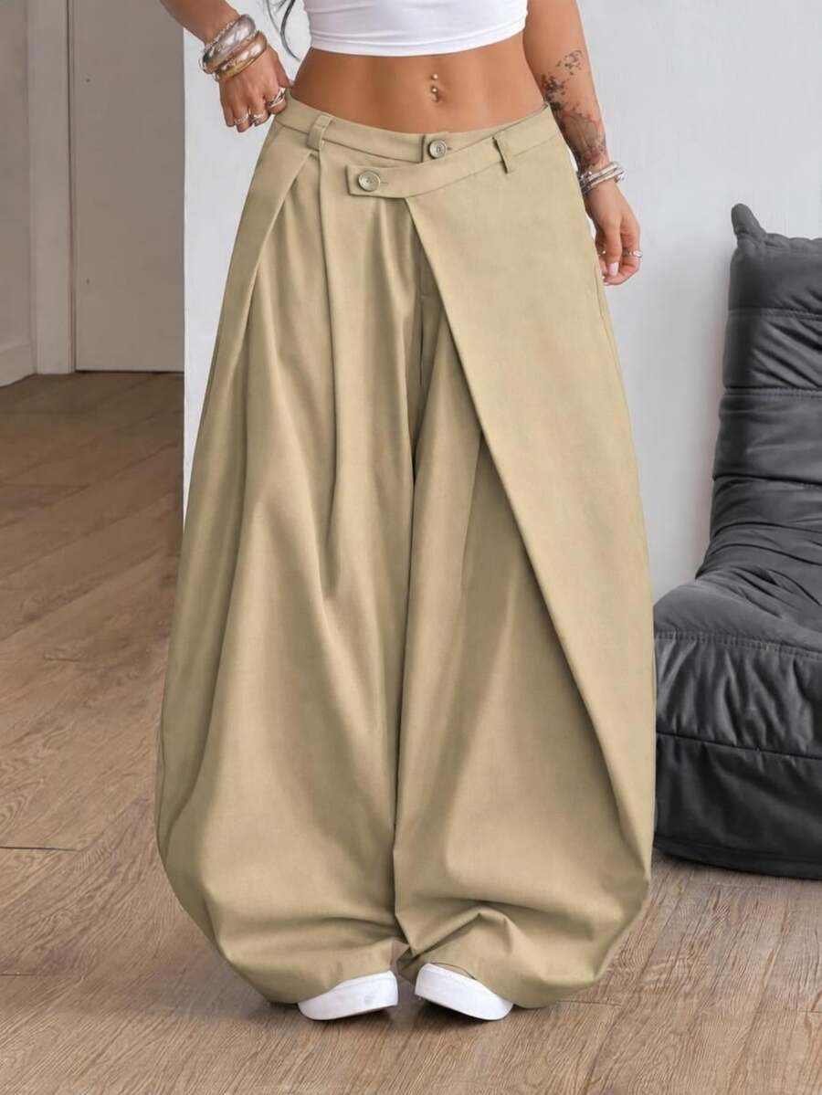 Front view of women's loose curved banana pants featuring a mid waist, side pockets, and asymmetrical plicated hem.