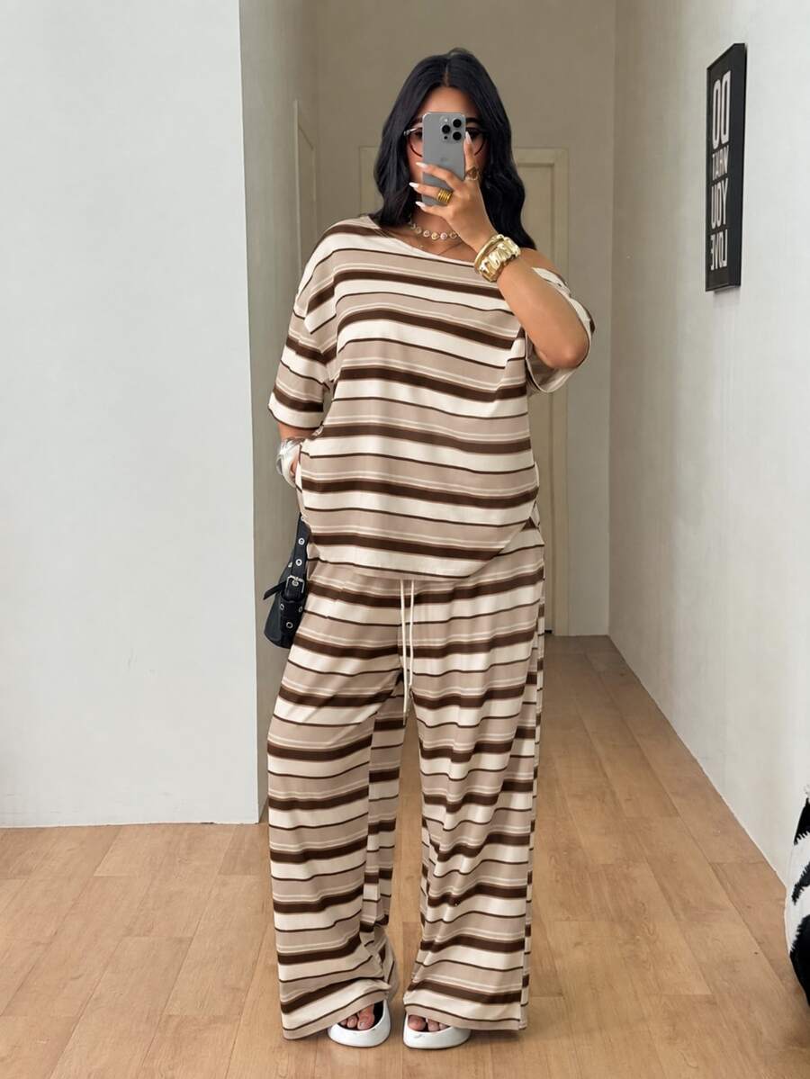 Striped two-piece casual outfit featuring an asymmetrical off-shoulder short-sleeve top and matching loose wide-leg pants with side pockets.