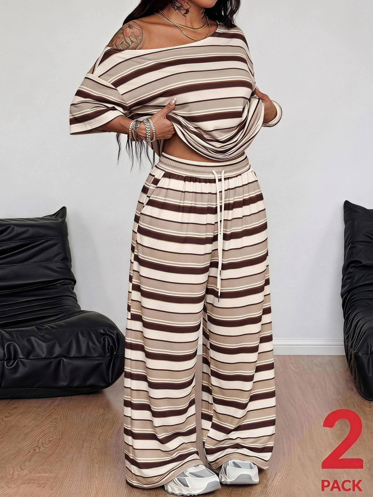 Striped two-piece casual outfit featuring an asymmetrical off-shoulder short-sleeve top and matching loose wide-leg pants with side pockets.