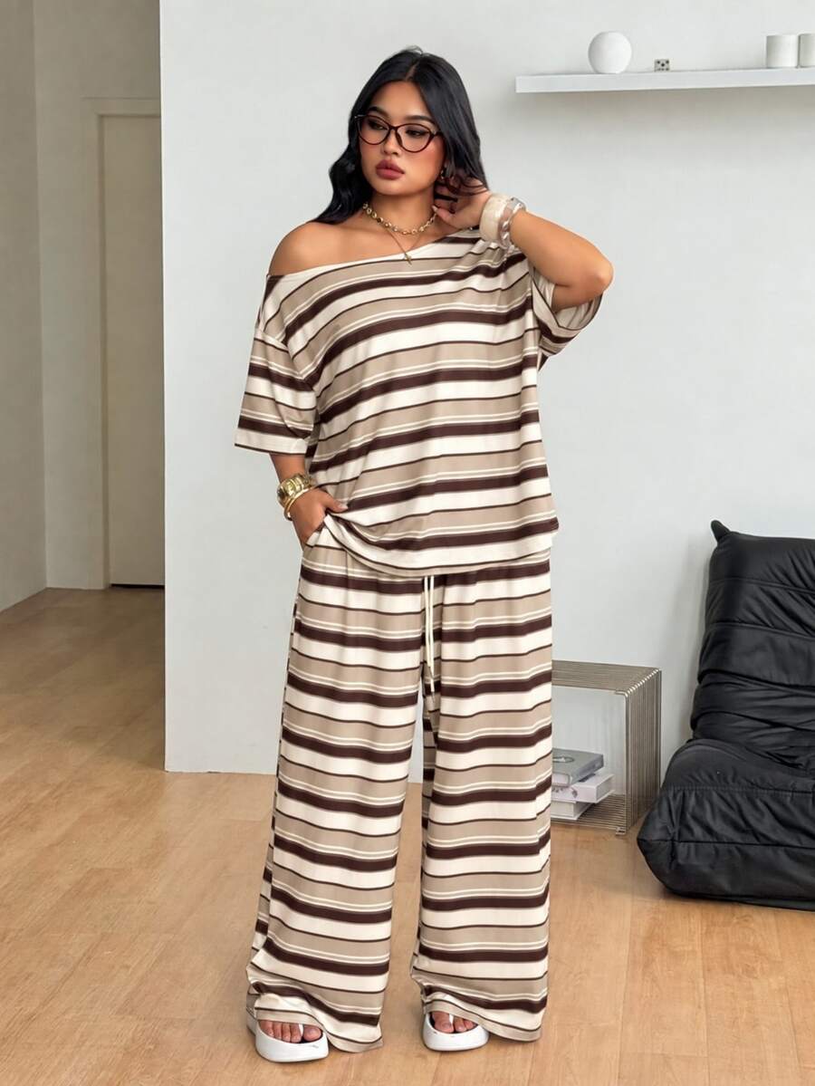 Striped two-piece casual outfit featuring an asymmetrical off-shoulder short-sleeve top and matching loose wide-leg pants with side pockets.