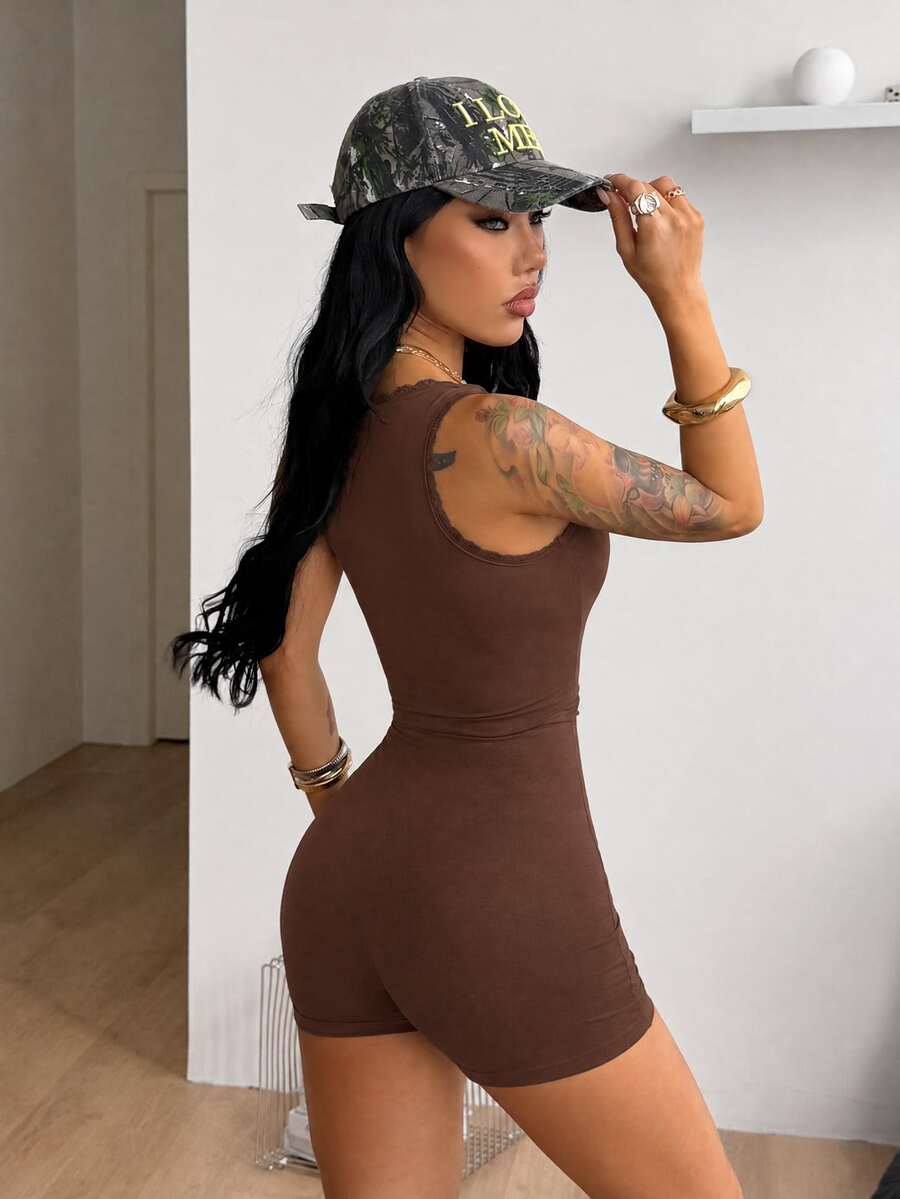 Women's black sleeveless unitard romper with a square neckline and backless design in stretchy knitted fabric.