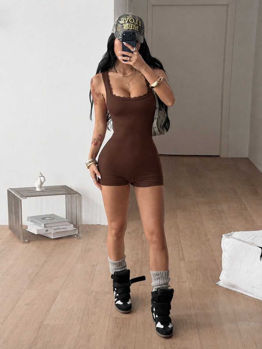 Women's black sleeveless unitard romper with a square neckline and backless design in stretchy knitted fabric.