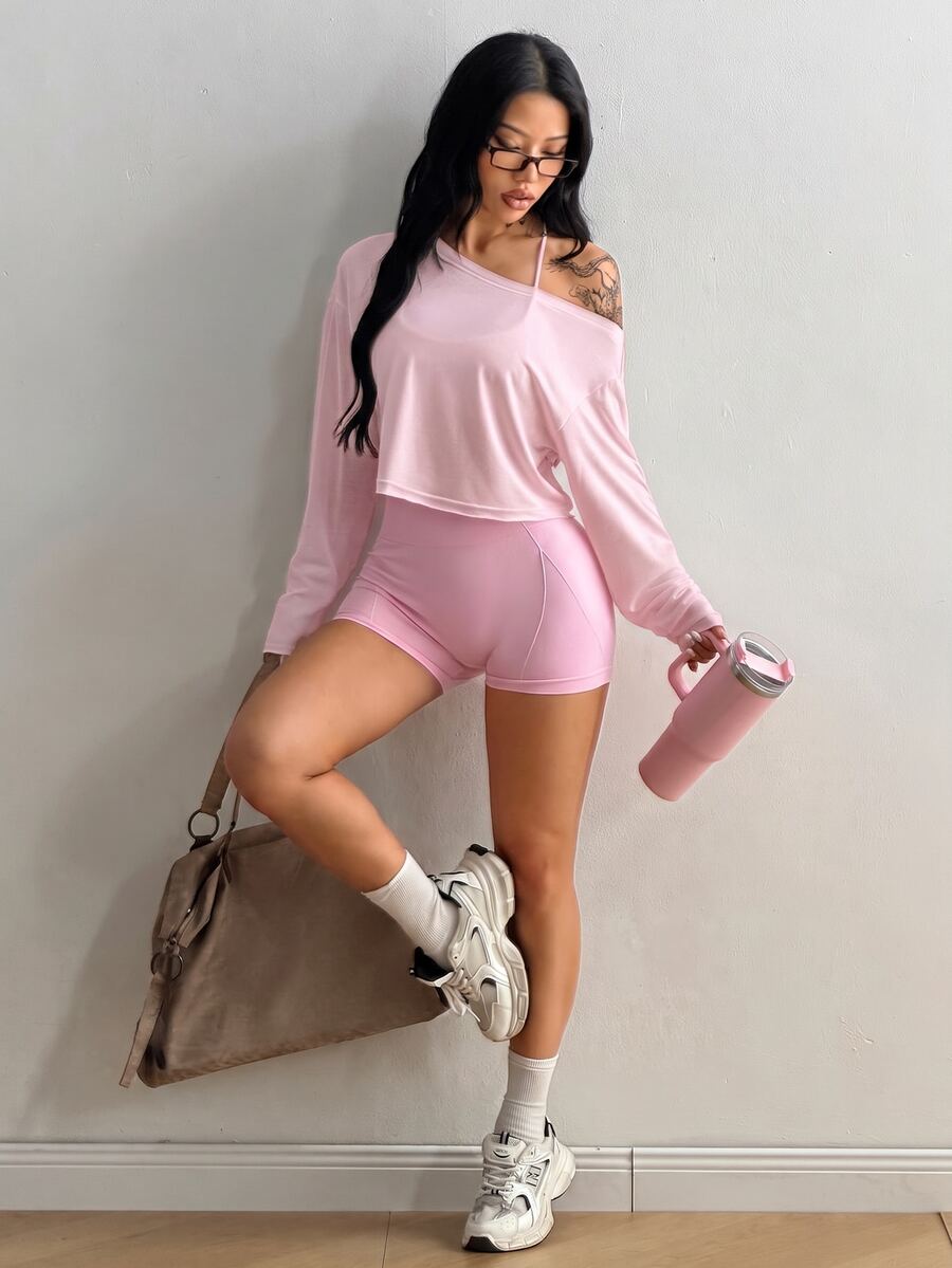 Women's white one shoulder rib-knit crop pullover top featuring an asymmetrical neckline, drop shoulder long sleeves, and a relaxed loose fit for yoga and athleisure wear.