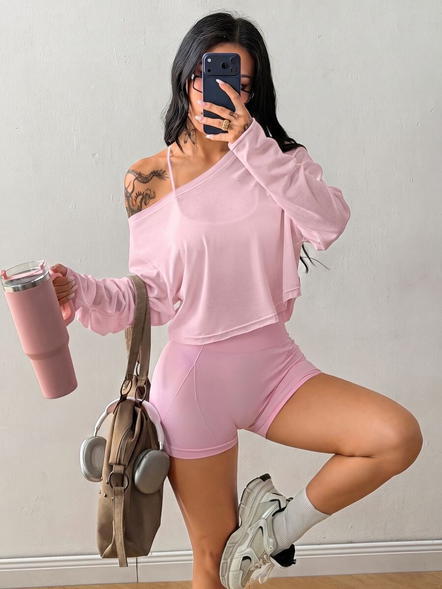 Women's white one shoulder rib-knit crop pullover top featuring an asymmetrical neckline, drop shoulder long sleeves, and a relaxed loose fit for yoga and athleisure wear.