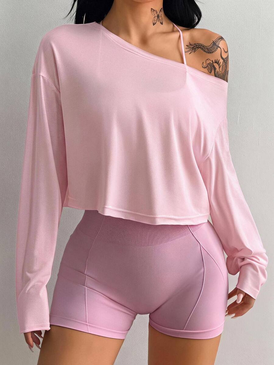 Women's white one shoulder rib-knit crop pullover top featuring an asymmetrical neckline, drop shoulder long sleeves, and a relaxed loose fit for yoga and athleisure wear.