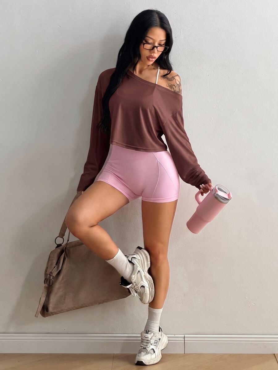 Women's white one shoulder rib-knit crop pullover top featuring an asymmetrical neckline, drop shoulder long sleeves, and a relaxed loose fit for yoga and athleisure wear.