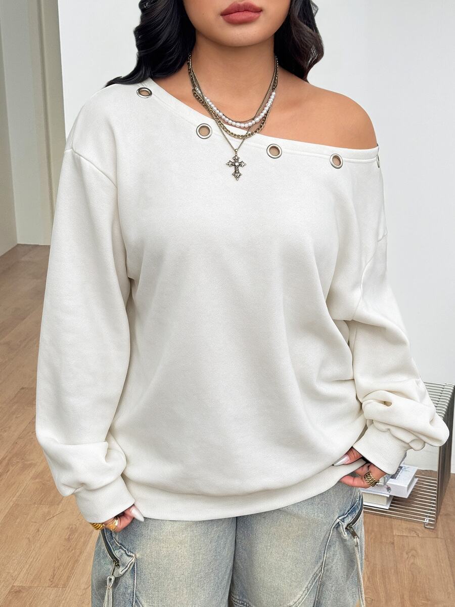 Women's oversized dark grey long sleeve sweatshirt featuring an asymmetrical boat neckline with grommet eyelet details and drop shoulders.