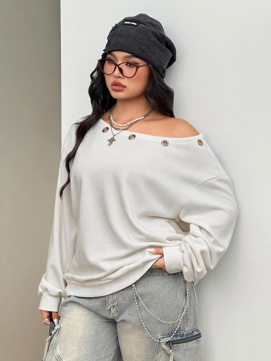 Women's oversized dark grey long sleeve sweatshirt featuring an asymmetrical boat neckline with grommet eyelet details and drop shoulders.