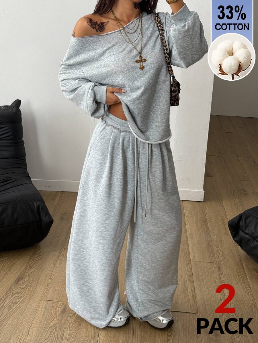 Women's two-piece casual lounge set featuring a loose drop-shoulder long sleeve sweatshirt and high-waist drawstring sweatpants with pockets.