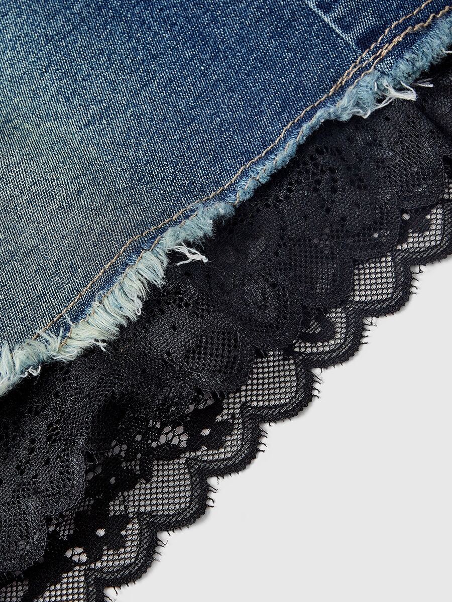 Front view of a women's plus size denim mini skirt with contrast lace trim and a fitted silhouette.