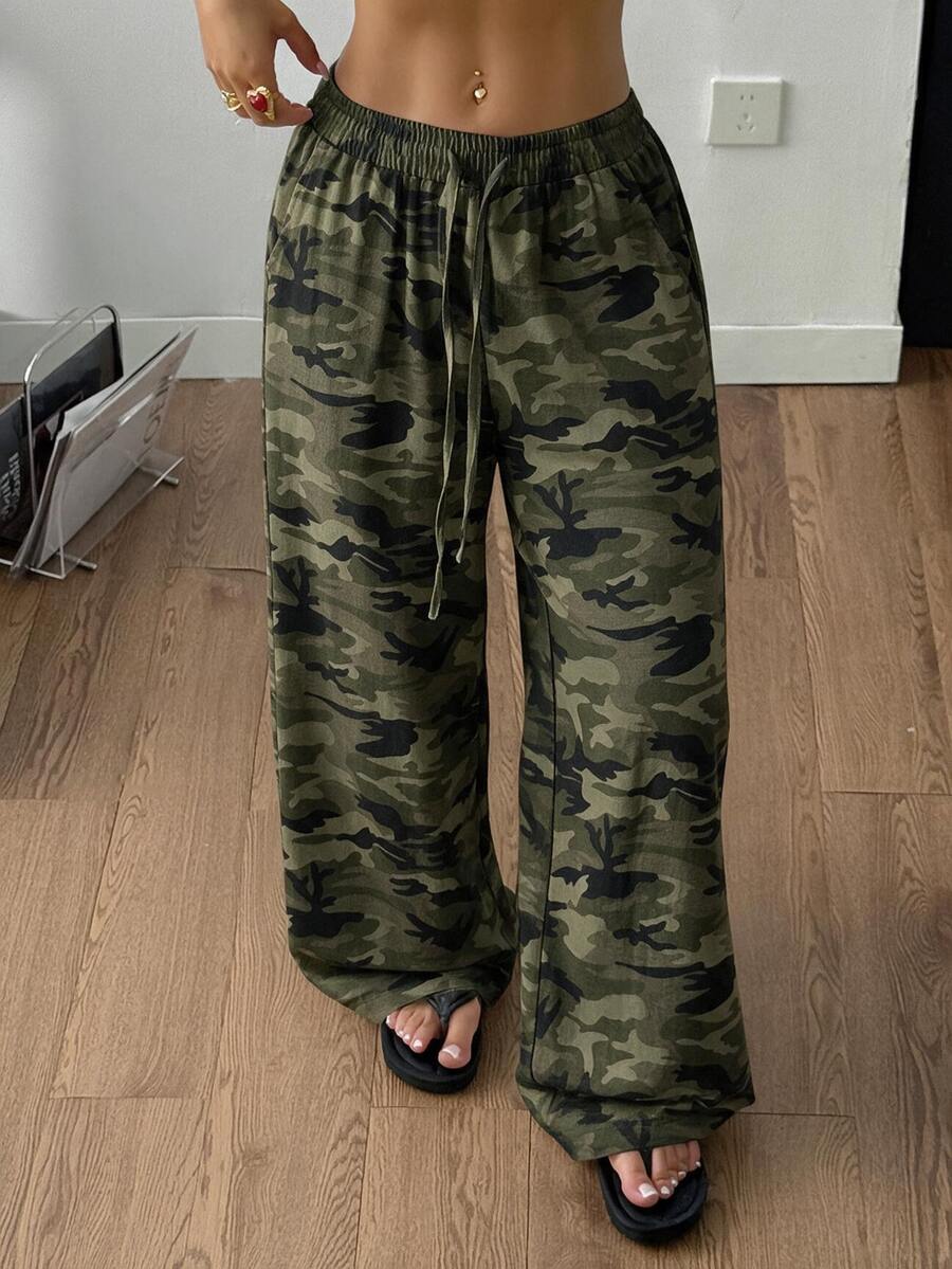 Women's plus size leopard print pants with an adjustable drawstring waist and loose straight leg fit.