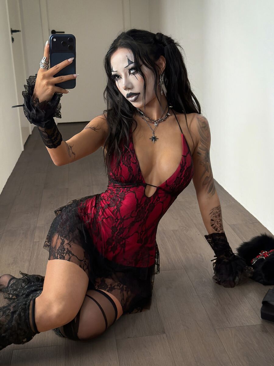 Front view of a women's lace halter mini dress featuring a slim-fit bodice, flared hem, and sleeveless design.